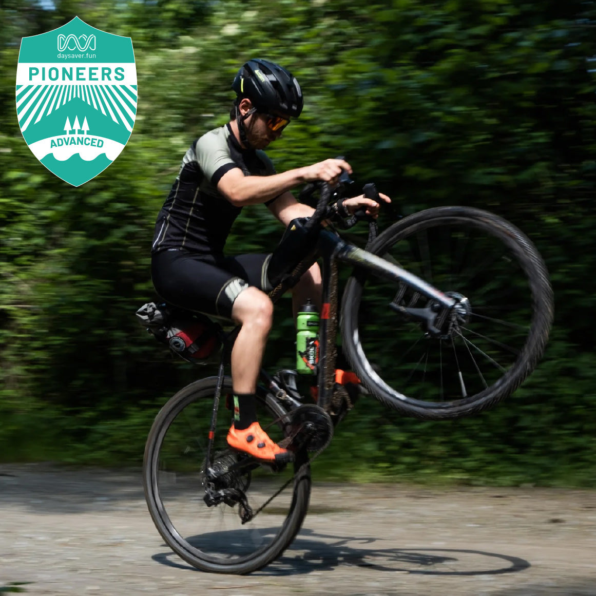 Person riding a bicycle on a trail with greenery in the background